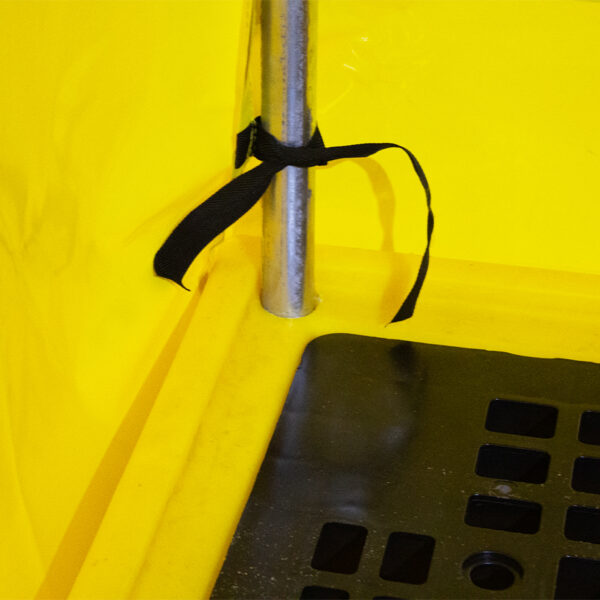 Spill pallet with cover tied in place