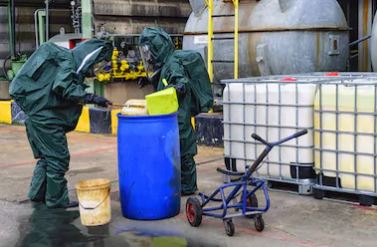Spill team sorting out an absorbent material for chemical spills otutside a warehosue.