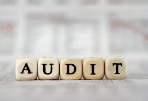 Image of small blocks spelling out AUDIT to represent the ISO 14001 audit
